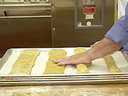 Pressing out loaves of biscotti